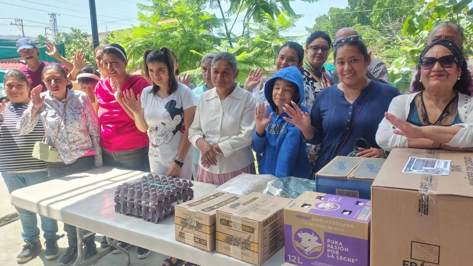 Personas reunidas con cajas de alimentos y suministros